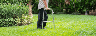 Man using walker on green grass