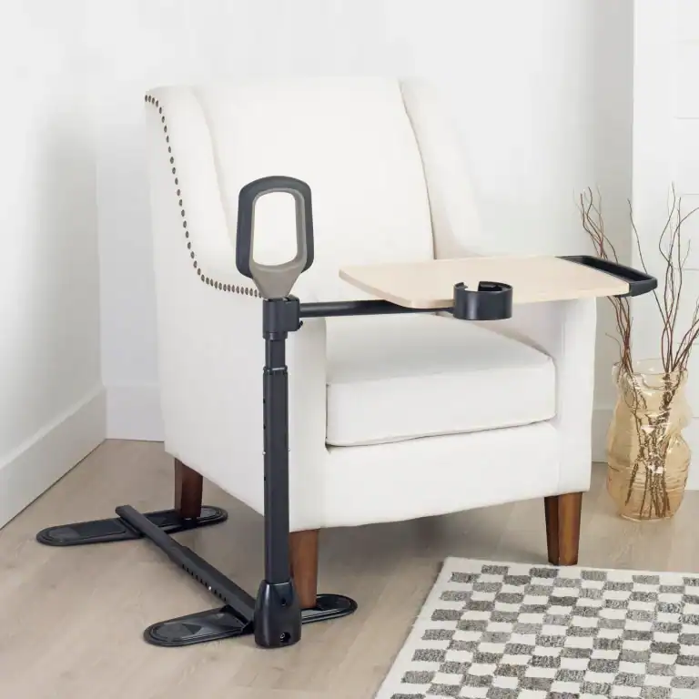 Assist-A-Tray attached to a white armchair for mobility support.
